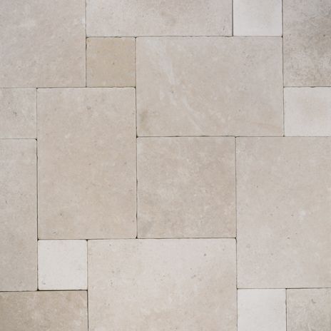 large and small yellow limestone bricks in a tessellated pattern