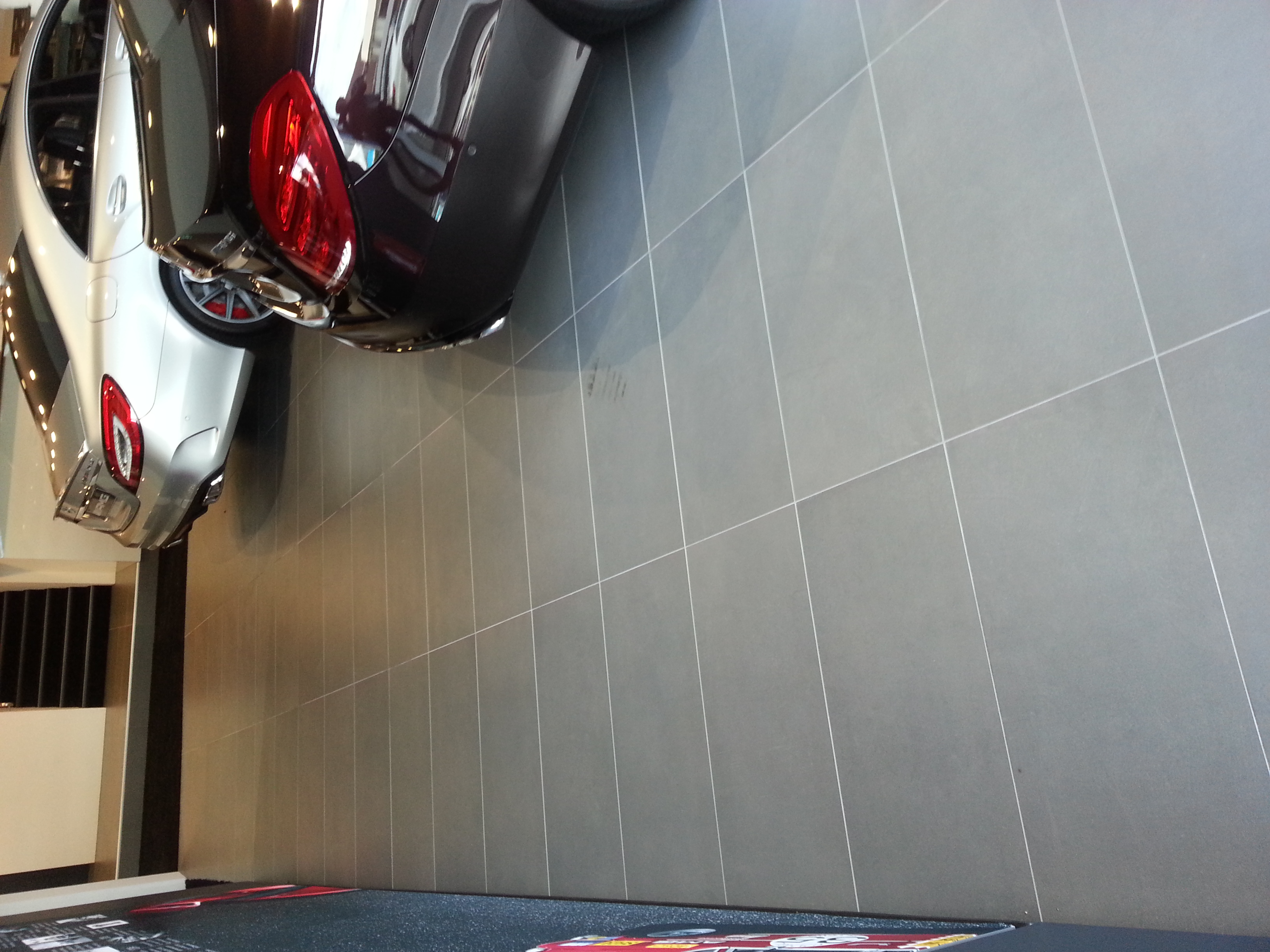 Natural stone tiles with two Mercedes Benz cars in a Showroom in fortitude valley brisbane
